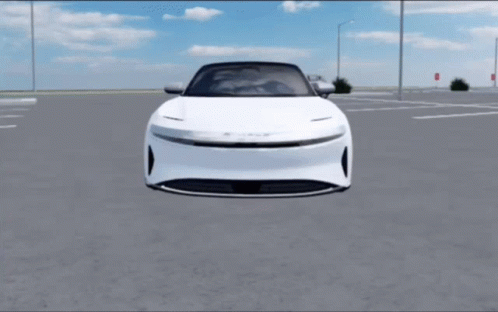 A White Car Is Parked In A Parking Lot With A Blue Sky In The Background GIF