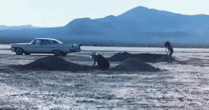A White Car Is Parked On The Side Of A Desert Road GIF