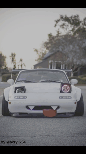 A White Car Is Parked On The Side Of The Road With A Picture Of It Taken By Acrylik56 GIF