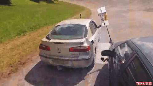 A White Car With A License Plate That Says 2 Nz GIF