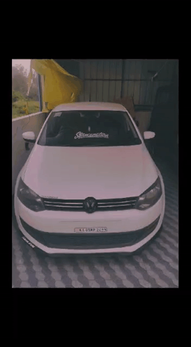 A White Car With A License Plate That Says K.e.o.s.m.p. GIF