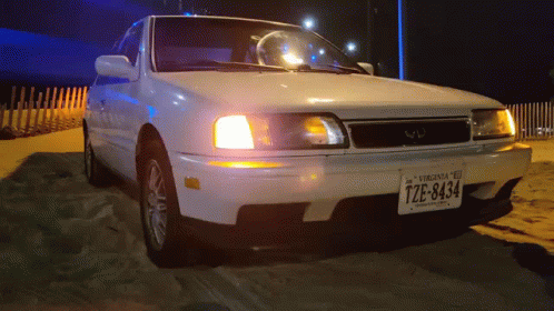 A White Car With A Virginia License Plate That Says Tze-8434 GIF