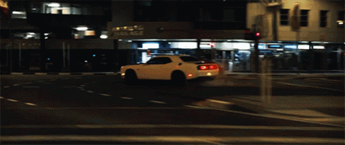 A White Car With The Letter C On The Tail Lights GIF