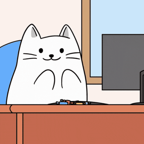 White Cat Sitting At Desk In Front Of Computer GIF