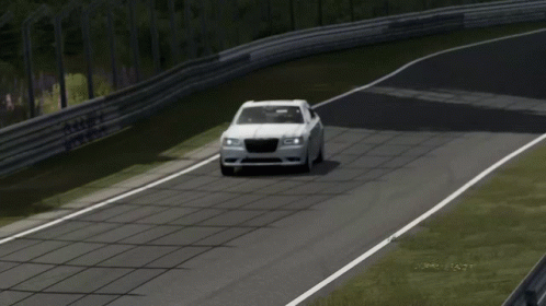 A White Chrysler Car Is Driving Down A Track GIF