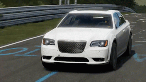 A White Chrysler Car Is Driving On A Road GIF
