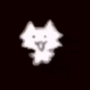 A White Cloud Is Floating In The Air On A Dark Background . GIF