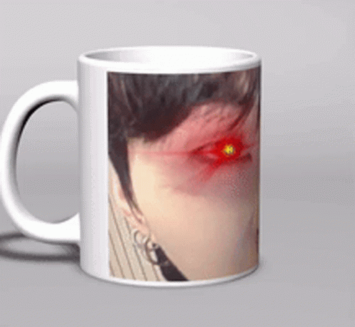 a white coffee mug with a picture of a woman 's face with red eyes
