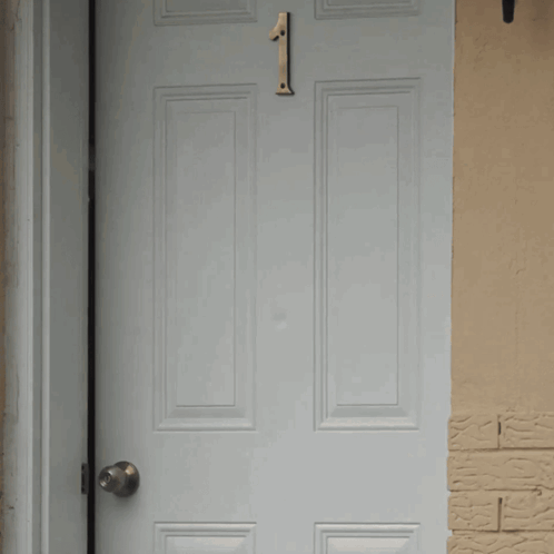 A White Door With A Number 1 On It GIF