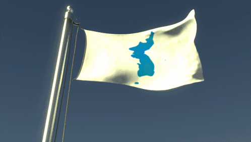 A White Flag With A Blue Island On It Is Flying In The Wind GIF