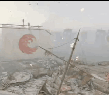 A White Flag With A Red Circle On It Is Hanging From A Pole In A Foggy Area . GIF