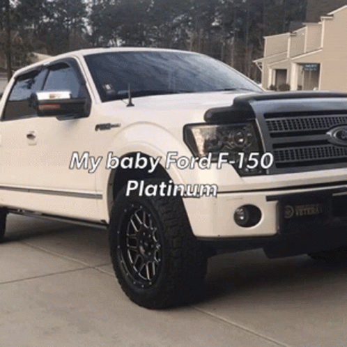 A White Ford F-150 Is Parked In A Driveway With The Caption My Baby Ford F-150 Platinum GIF