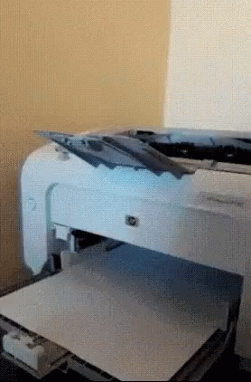 A White Hp Printer Is Sitting On A Table GIF