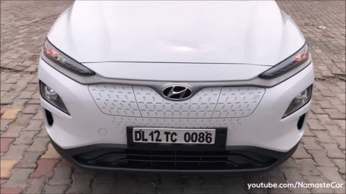 A White Hyundai Car Has A License Plate That Says Dl12tc 0086 GIF