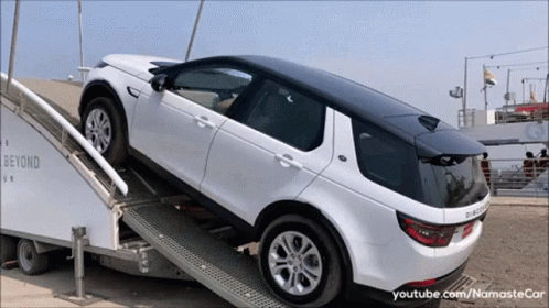 A White Land Rover Is On A Ramp That Says Beyond Ur GIF