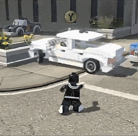 A White Lego Car Is Parked In Front Of A Building With A Yellow Y On It GIF