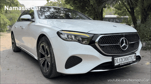 A White Mercedes With A License Plate That Says Dl12c0007tc GIF