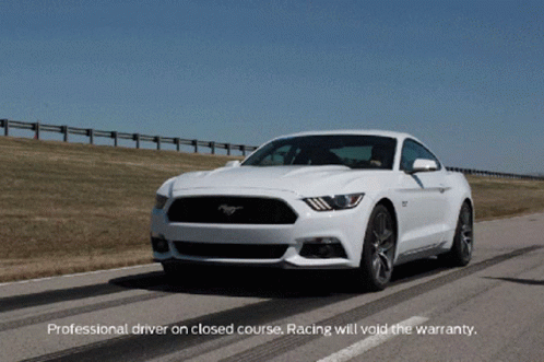 A White Mustang Is Driving Down A Road With The Words Professional Driver On Closed Course Racing Will Void The Warranty GIF