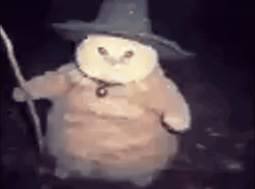 A White Owl Wearing A Wizard Hat And Holding A Wand . GIF