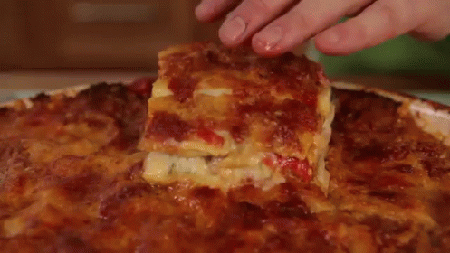 A White Plate Topped With A Slice Of Lasagna . GIF