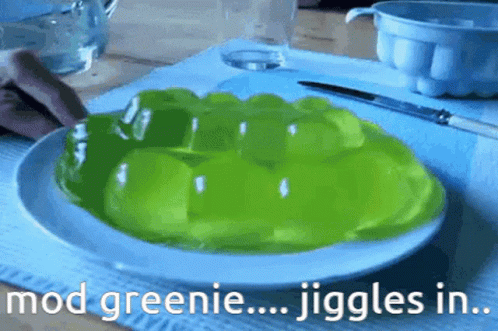 A White Plate Topped With Green Jelly With The Words Mod Greenie Jiggles In GIF