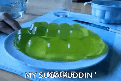 A White Plate Topped With Green Pudding With The Words My Sugar Pudding Written On It GIF