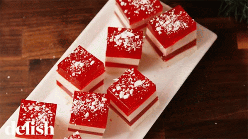 A White Plate Topped With Red And White Squares With The Word Delish On The Bottom Right GIF