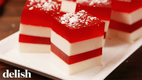 A White Plate Topped With Slices Of Red And White Candy Cane Jelly GIF