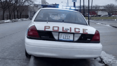 A White Police Car With A License Plate That Says 4412 GIF