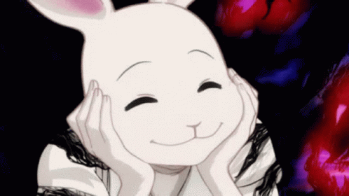 A White Rabbit Is Smiling And Holding Its Head With Its Hands . GIF