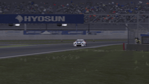 A White Race Car Is Driving Down A Track With The Word Motul On The Side GIF