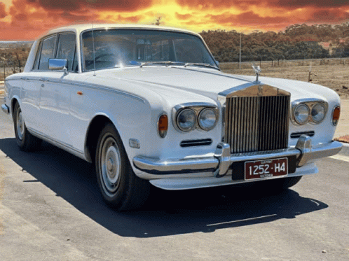 A White Rolls Royce With A License Plate That Reads 1252 H4 GIF