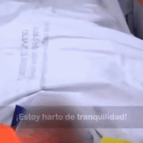 A White Shirt With The Words Estoy Harto De Tranquilidad GIF