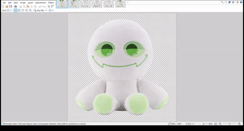 A White Stuffed Animal With Green Eyes And A Smiley Face GIF