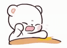 A White Teddy Bear Is Sitting At A Table With Its Mouth Open . GIF