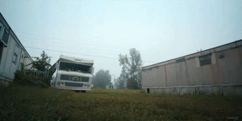 A White Truck Is Parked In A Grassy Field Next To A Trailer That Says Techstuff GIF