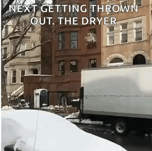A White Truck Is Parked In Front Of A Building With The Words Next Getting Thrown Out The Dryer GIF