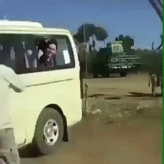 A White Van Is Parked On The Side Of A Road GIF