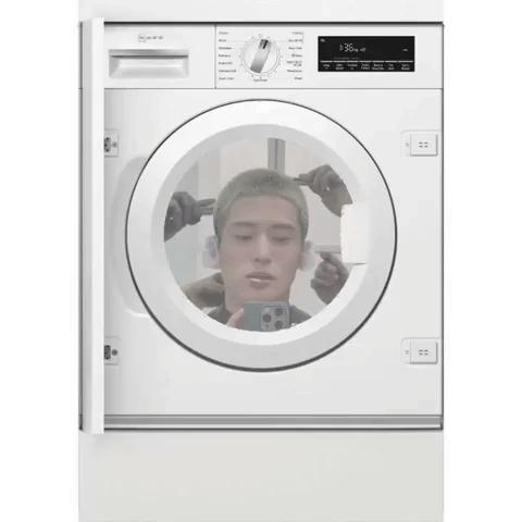A White Washing Machine Has A Picture Of A Man 'S Head In It GIF