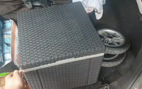 A Wicker Ottoman Sits In The Back Of A Car GIF