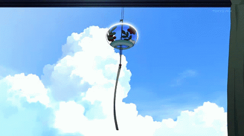 A Wind Chime Hanging From A Window With Tokyo Mx On The Bottom Right Corner GIF