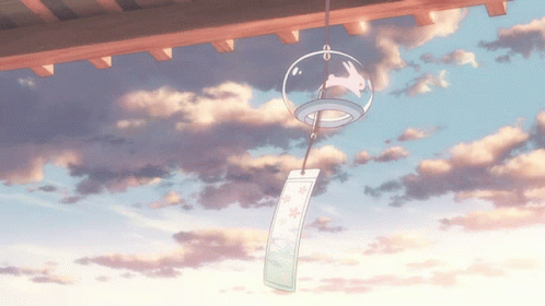 A Wind Chime With A Rabbit On It Hangs From The Roof GIF
