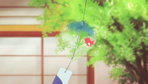 A Wind Chime With A Red Fish In It Is Hanging From A String GIF