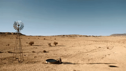 A Windmill In The Middle Of A Dry Desert GIF