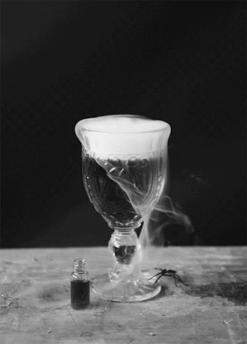 A Wine Glass With Smoke Coming Out Of It GIF