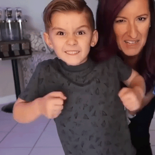 A Woman And A Child Are Posing For A Picture GIF