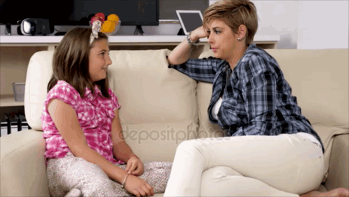 A Woman And A Girl Are Sitting On A Couch Talking GIF