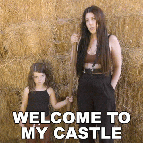 A Woman And A Little Girl Are Standing In Front Of Hay Bales With The Words Welcome To My Castle Written On The Bottom GIF