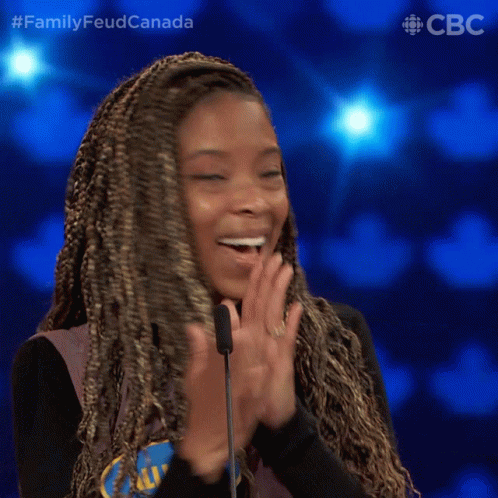 A Woman Applauds In Front Of A Microphone With The Words Family Feud Canada On The Bottom Right GIF