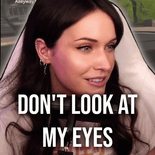 A Woman Behind A Microphone With The Words " Do N't Look At My Eyes " On The Bottom GIF